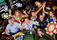 Happy group of people winning at the casino